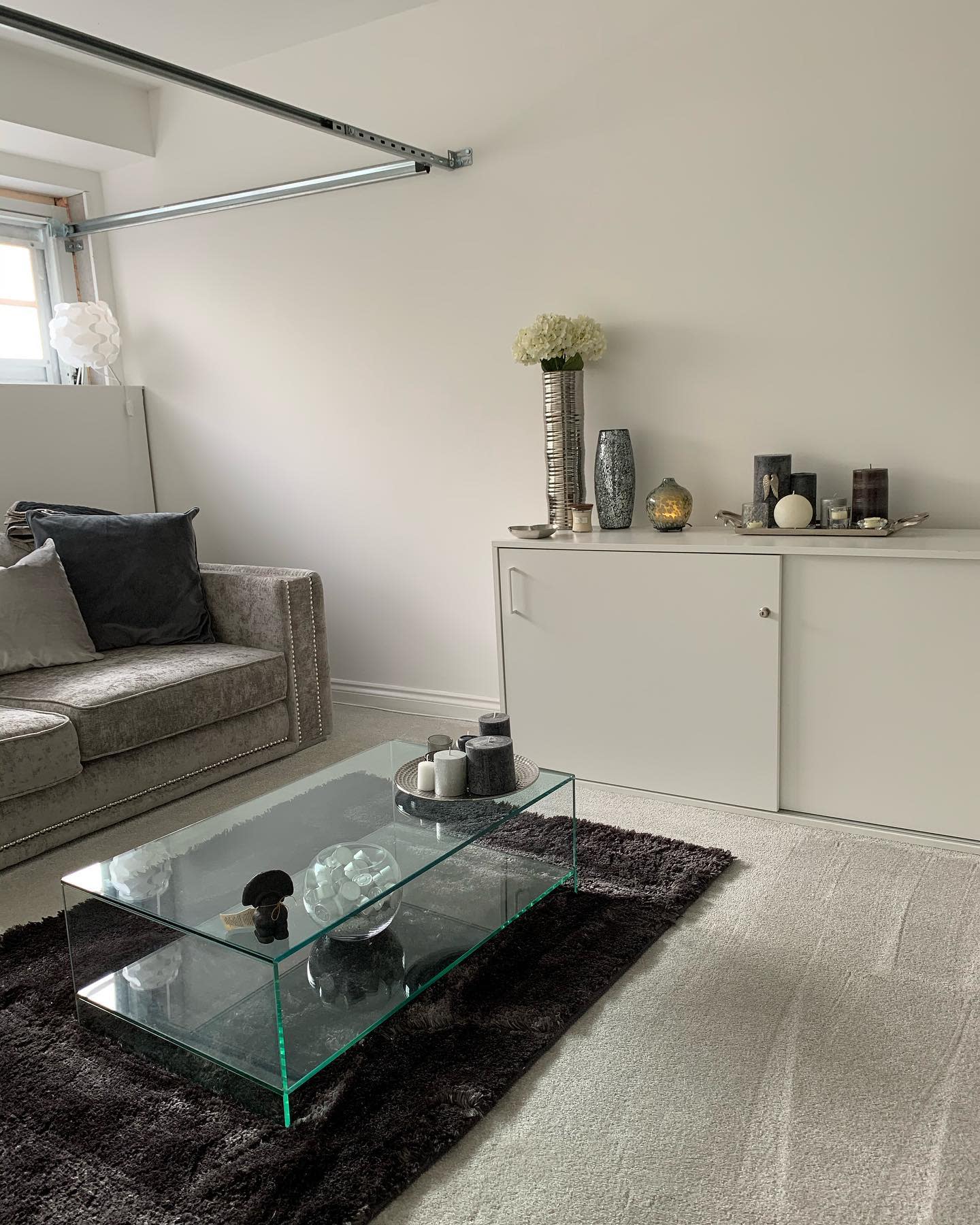 garage living room gray sofa and cabinet glass coffee table 
